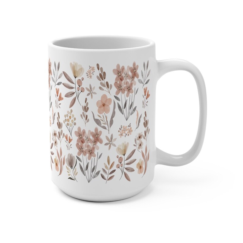 May include: White ceramic mug with a floral pattern in shades of brown and pink. The mug features a repeating design of various flowers and leaves.