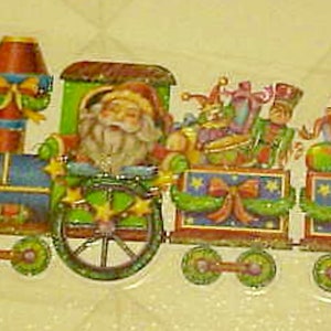 May include: A colorful Christmas train decoration featuring Santa Claus in the engine, with carriages carrying gifts and toys. The train is decorated with bows, stars, and festive colors, perfect for holiday decor.