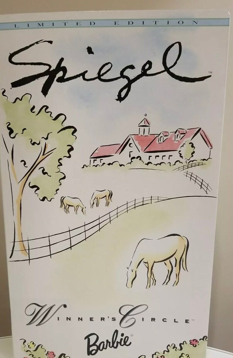 May include: A limited edition Barbie box with a pastoral scene. The illustration features a farm with horses grazing in a field, a farmhouse, and the text "Spiegel" and "Winner's Circle Barbie".