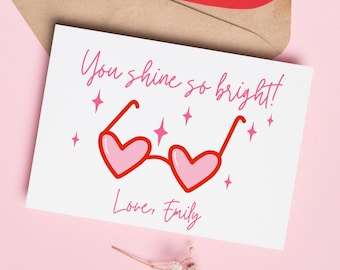 May include: A white card with pink and red heart-shaped sunglasses and the text "You shine so bright!" and "Love, Emily".