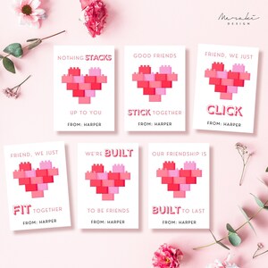 May include: Six printable Valentine's Day cards featuring a heart made of colorful toy building blocks. Each card has a different message about friendship, such as "Nothing stacks up to you" and "We're built to be friends".