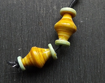 A pair of Polymer clay, Stripe Painted, Turned look, Faux ceramic Spindle beads in Yellow, orange and pale blue