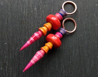 A pair of Stripe Painted, Turned look, Faux ceramic, Rustic, Tribal style Spikes in Orange, yellow, pink and purple