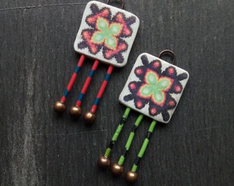 A pair of Abstract Pattern, Flat, Geometric Image transfer Tile bead and wire drops in Green, red, black and white