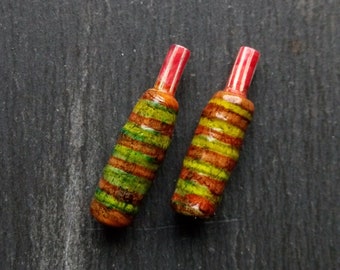 A pair of Stripe Painted, Turned look, Part textured, Rounded, Spindle beads in Brown, green, red and white