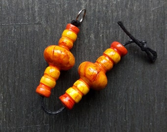 A pair of Stripe Painted, Turned look, Faux ceramic, Crackle glaze, Tribal style Spindle tube beads in Orange and yellow