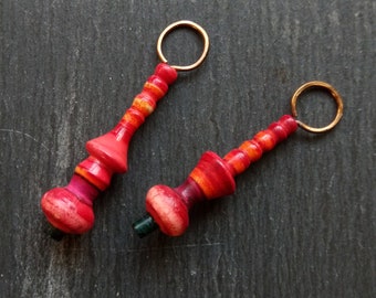 A pair of Stripe Painted, Turned look, Faux ceramic, Rustic, Tribal style Spindle charms in Pink, red, orange and black