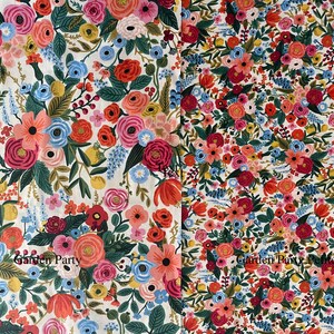 May include: A white fabric with a floral pattern featuring red, pink, blue, and yellow flowers. The fabric has the text "Garden Party" printed on it.
