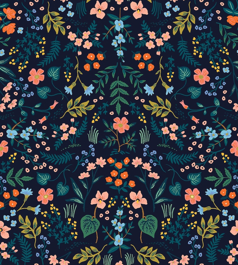 May include: A floral pattern featuring a dark navy background with a symmetrical arrangement of flowers and foliage. The design includes peach, orange, blue, and yellow flowers, along with green leaves and stems. The overall aesthetic is botanical and decorative.