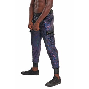 May include: Black cargo pants with a iridescent finish. The pants have a drawstring waistband and a flap pocket on the right leg.