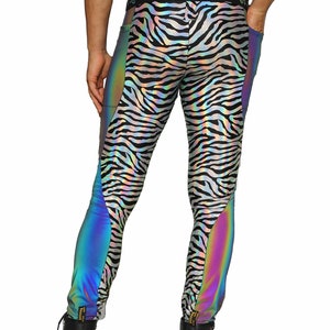 May include: Black and white zebra print leggings with iridescent rainbow panels on the sides. The leggings have a black waistband with the text "Love. Chaos" printed on it.