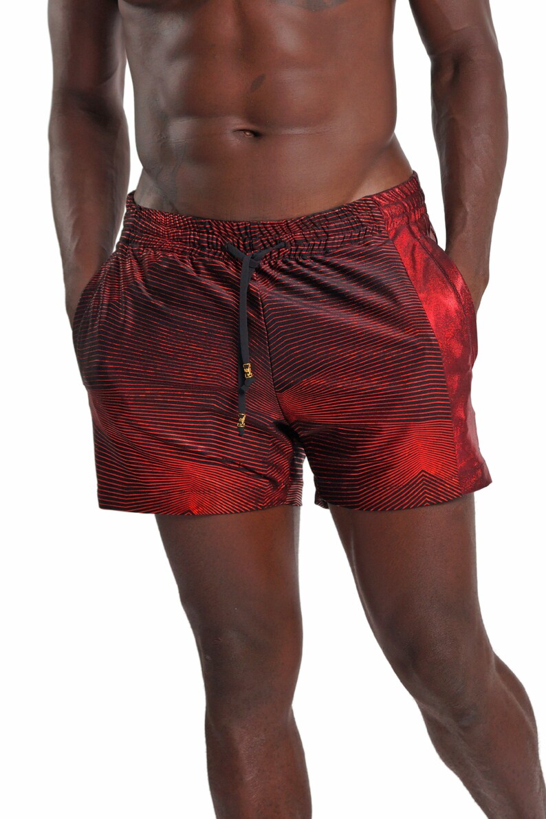 May include: Red and black striped swim trunks with a shiny metallic side panel.