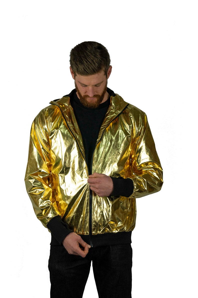 Metallic gold windbreaker for men, with black thumbhole cuffs, full-zip front, and hood by Love Khaos