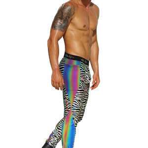 May include: A person wearing black and white zebra print leggings with a rainbow iridescent panel on the side. The leggings have a black waistband with the text "Let's Move" printed on it. The person is wearing black boots.