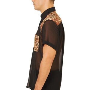 May include: A black sheer button-down shirt with a leopard print design on the shoulders and a pocket. The shirt has short sleeves and a drawstring at the bottom.