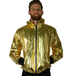 Metallic gold windbreaker for men, with black thumbhole cuffs, full-zip front, and hood by Love Khaos
