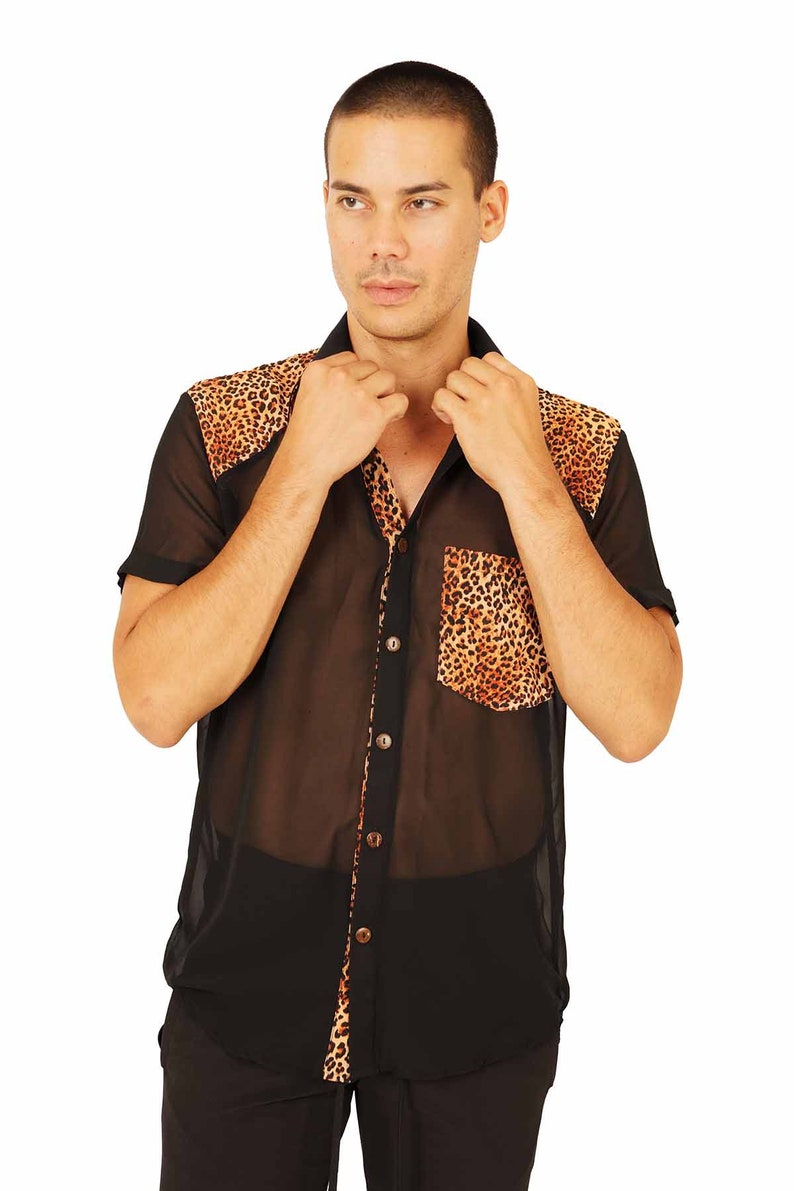 May include: A sheer black button-up shirt with a leopard print pattern on the collar and pocket. The shirt is made of a lightweight, translucent fabric.