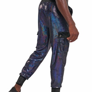 May include: Black cargo pants with a iridescent sheen. The pants have a drawstring waistband and a flap pocket on the right leg.