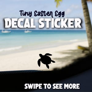 Könnte beinhalten: Schwarzer Schildkröten-Aufkleber mit dem Text "Tiny Easter Egg DECAL STICKER" in Weiß und Blau. Der Hintergrund zeigt eine Strandszene mit dem Text "SWIPE TO SEE MORE".