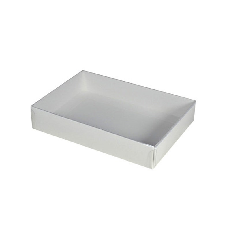 May include: A white rectangular box with a smooth, flat surface. The box is empty and has a slight sheen.
