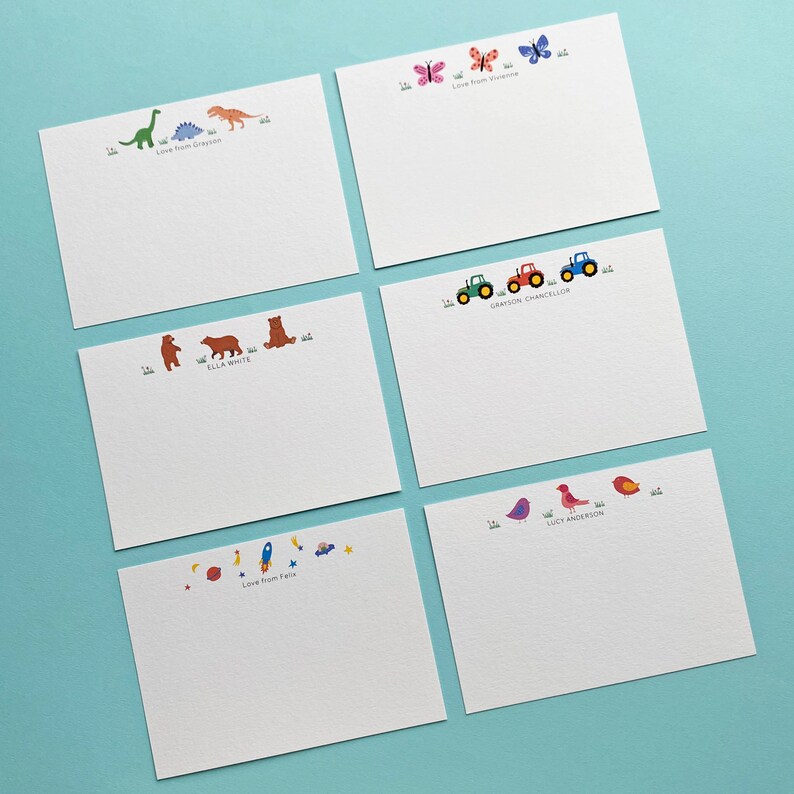 May include: Set of six blank note cards with colourful illustrations and personalised names. The illustrations include dinosaurs, butterflies, bears, tractors, birds and rockets.