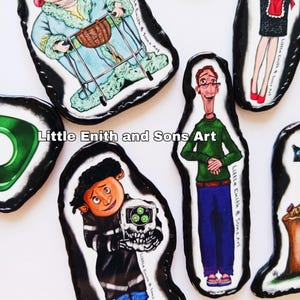 May include: A collection of colorful, cartoon-style illustrations on black, irregular-shaped backgrounds. The illustrations depict various characters, including a woman with a walker, a man in a green shirt, and a child holding a skull. The text "Little Enith & Sons Art" is visible.