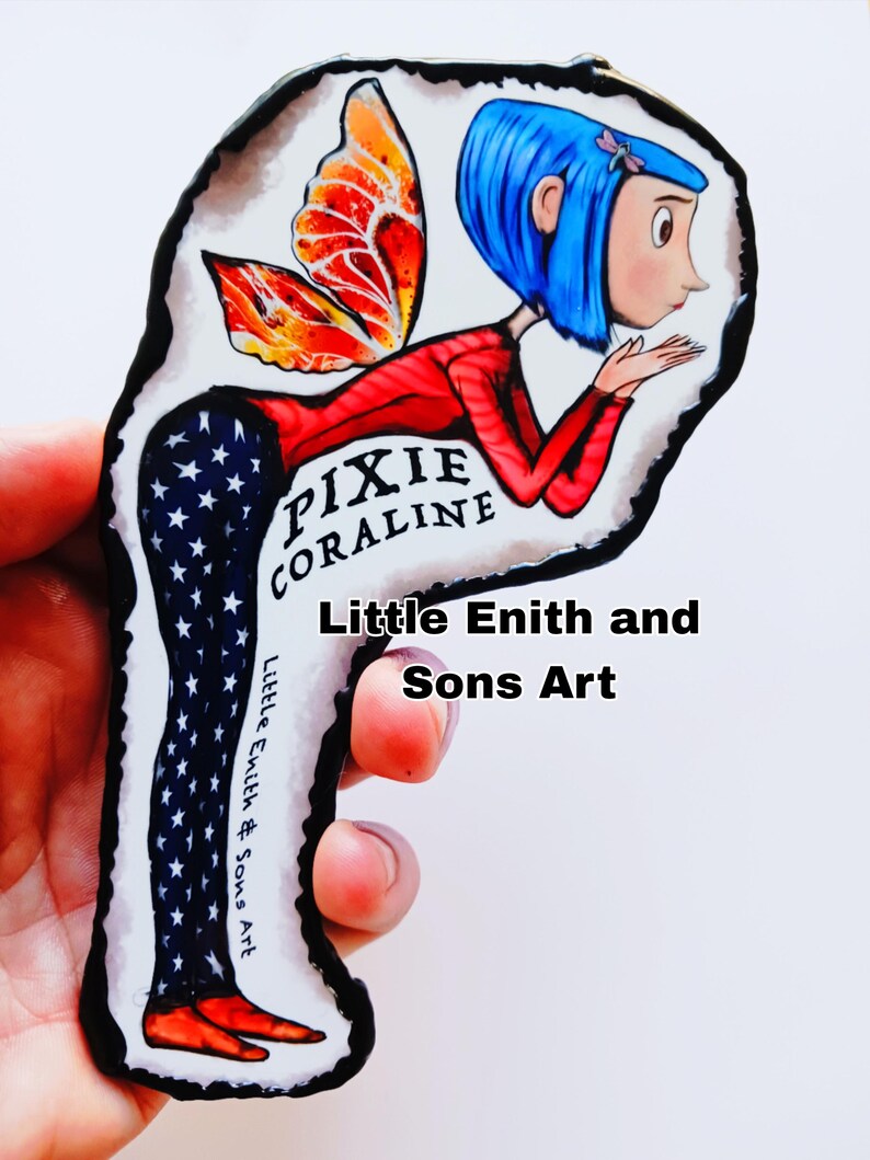 May include: A hand-painted art piece featuring a cartoon character with blue hair, red top, and star-patterned pants. The character has orange and red wings and the text "Pixie Coraline". The art is signed "Little Enith & Sons Art".
