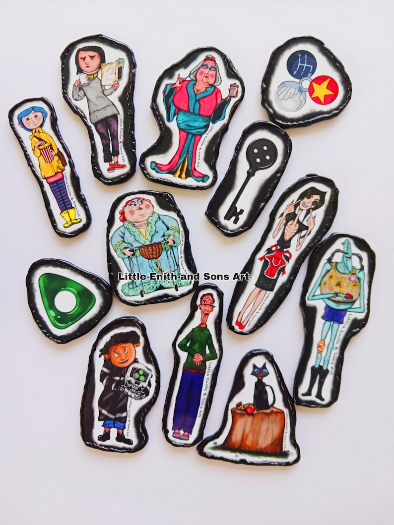 May include: A collection of illustrated character magnets with black borders. The magnets feature characters from a movie, including a girl in a yellow raincoat, a woman in a red dress, and a black cat. The text "Little Enith and Sons Art" is visible.