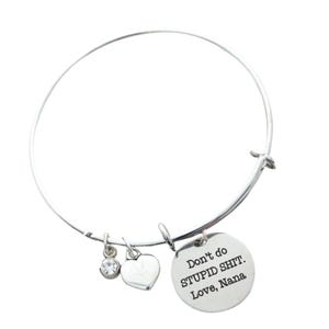 May include: Silver bangle bracelet with a charm that reads "Don't do STUPID SHIT. Love, Nana". The charm is attached to a small heart and a clear rhinestone.
