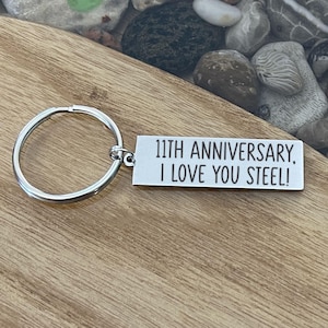 May include: Silver keychain with a silver tag that reads "11th Anniversary, I love you Steel!"