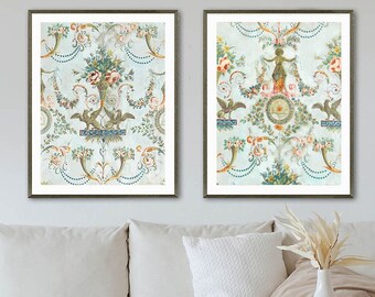 May include: Two framed prints with a vintage floral pattern. The prints feature a light blue background with intricate floral designs in shades of pink, green, and yellow. The frames are silver with a distressed finish.