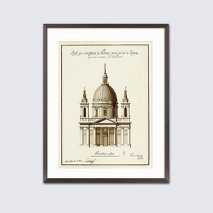 May include: Framed sepia-toned architectural print depicting a domed building with columns and towers. The print includes text at the top and bottom, set against a white background within a dark frame. A classic piece of art.