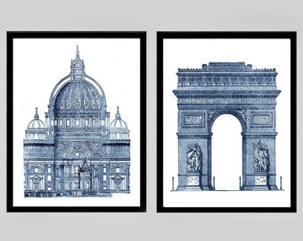 May include: Two framed prints of famous architectural landmarks in a blue and white color scheme. The print on the left shows the Basilica di San Pietro in Rome, Italy. The print on the right shows the Arc de Triomphe in Paris, France.