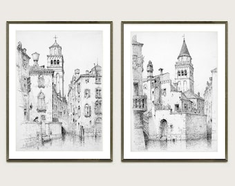May include: Two black and white line drawings of buildings in Venice, Italy. The drawings are framed in gray frames and are hung on a white wall.