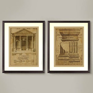 May include: Two framed prints of architectural drawings. The left print shows a detailed plan of a classical building with columns and a pediment. The right print shows a detailed drawing of a Doric capital with labels for each part.
