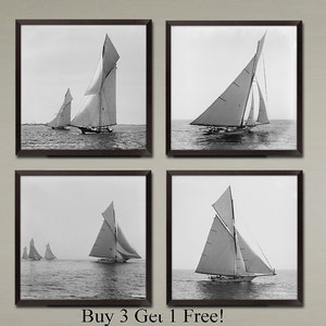 May include: A set of four black and white photographs of sailboats on the water. The sailboats are all different sizes and have different sail configurations. The photos are framed in black frames.
