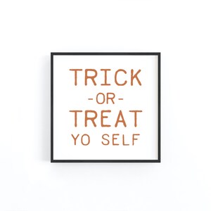 May include: A black framed print with the text "TRICK -OR- TREAT YO SELF" in orange.