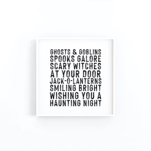 May include: A white framed print with black text that reads "Ghosts & Goblins, Spooks Galore, Scary Witches, At Your Door, Jack-O-Lanterns, Smiling Bright, Wishing You A Haunting Night."