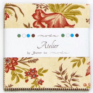 May include: A stack of fabric squares with a floral pattern in red, green, and brown on a cream background. The fabric is labeled "Atelier" by 3 sisters for moda.