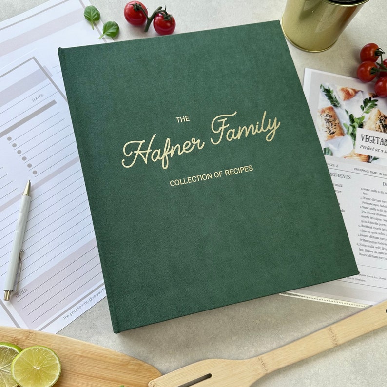 Dark green recipe book with custom text in gold color on the cover.  The book is thick and has a luxurious feel. It's a high-quality, personalized recipe book for storing family recipes.