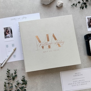 Ivory Instax Wedding Guest Book With Copper Lettering, This modern Polaroid Guest book is more than just a sign-in book, this luxurious and personalized Instax photo album fits all instant film sizes — Instax Mini, Wide, Square, Photo Booth 4x6 prints, and 2x6 photo strips. Our wedding photo guest book that captures every smile, every laugh, and every special guest who made your day unforgettable — a timeless wedding keepsake you’ll treasure forever.