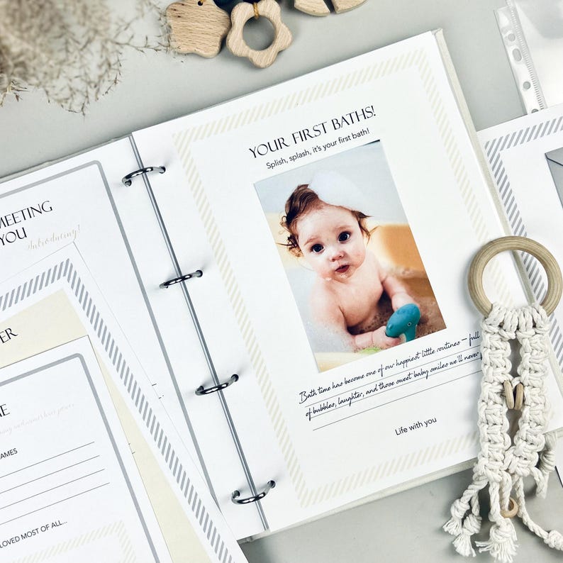 Inside pages of a handmade baby memory book designed to capture milestones and photo memories. Each page features dedicated spaces for firsts like smiles, steps, birthdays, and family moments. With its soft, minimal layout, parents can easily add, remove, or rearrange pages as their baby grows. Thoughtfully designed with photo areas and prompts for notes, this keepsake helps preserve every special moment from birth through the early years in a beautifully organized way.
