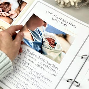 Inside pages of a handmade baby memory book designed to capture milestones and photo memories. Each page features dedicated spaces for firsts like smiles, steps, birthdays, and family moments. With its soft, minimal layout, parents can easily add, remove, or rearrange pages as their baby grows. Thoughtfully designed with photo areas and prompts for notes, this keepsake helps preserve every special moment from birth through the early years in a beautifully organized way.