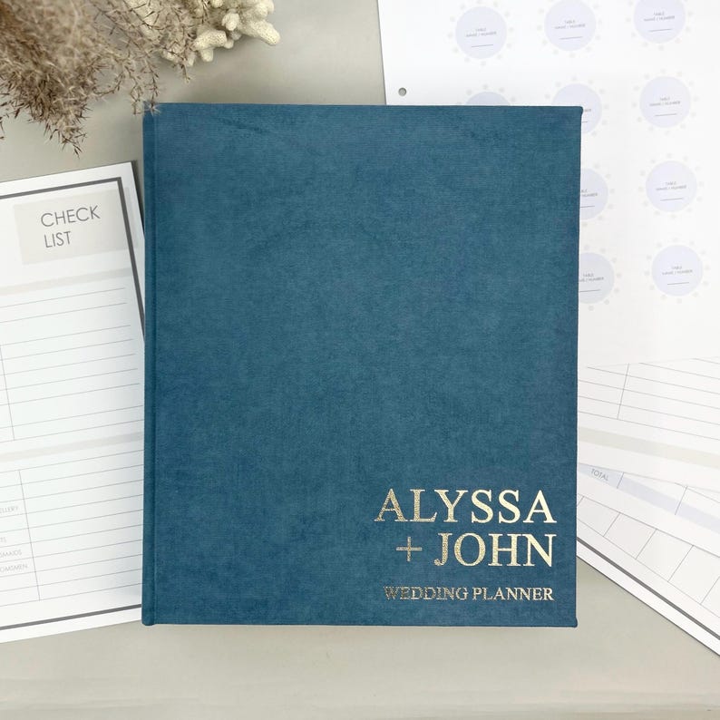 Personalized wedding planner binder to organize your entire wedding in one place — includes all checklists, timelines, budget sheets, and vendor contract sections. Fully customizable cover and spine colors with your names, wedding date, or custom text. Perfect keepsake for brides and wedding planners to stay organized from engagement to wedding day.