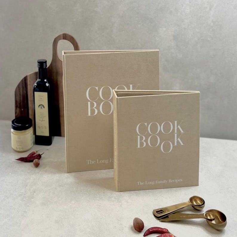 Two recipe book binders in A4 and A5 sizes showing the difference between them. Binders are in Beige color with White lettering/text on the cover.