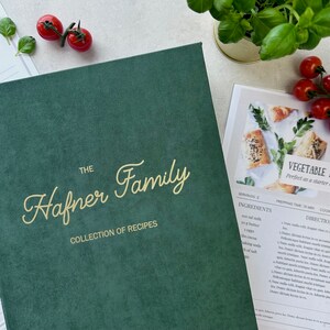 Dark green recipe book with custom text in gold color on the cover.  The book is thick and has a luxurious feel. It's a high-quality, personalized recipe book for storing family recipes.