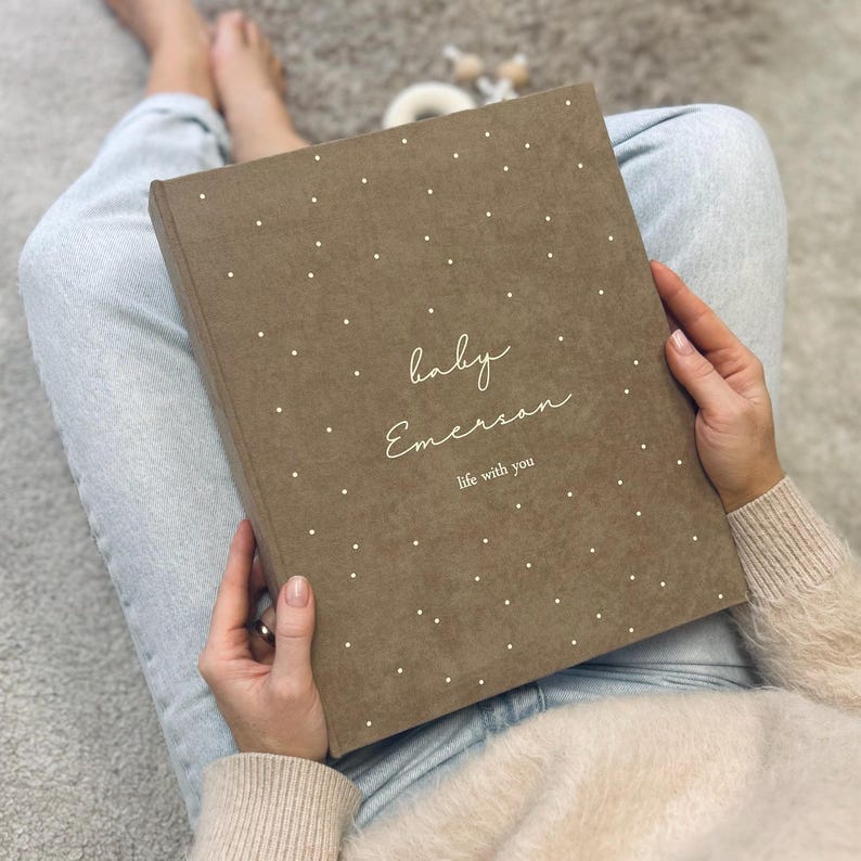 A handmade Dusty Pink color Baby Memory Binder with elegant White lettering on the cover. A beautifully designed keepsake to document your little one’s journey from birth to five years. Inside, you’ll find customizable pages for milestones, firsts, family memories, and photos — with space for notes and keepsakes too. Refillable and thoughtfully crafted, this baby binder helps parents cherish and organize memories — a timeless, heartfelt gift and family treasure.