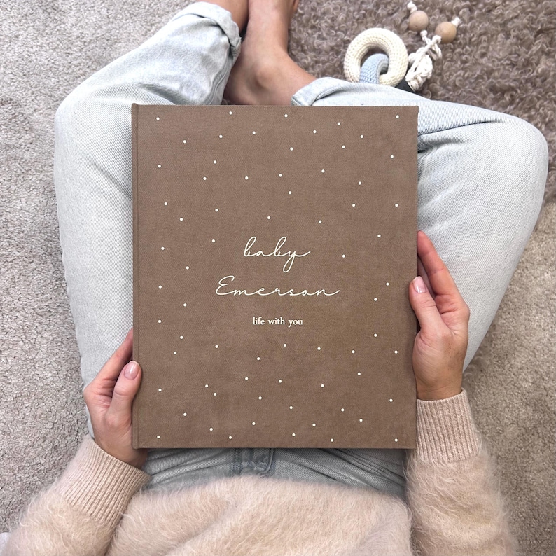 A handmade Brown color Baby Memory Binder with elegant White lettering on the cover. A beautifully designed keepsake to document your little one’s journey from birth to five years. Inside, you’ll find customizable pages for milestones, firsts, family memories, and photos — with space for notes and keepsakes too. Refillable and thoughtfully crafted, this baby binder helps parents cherish and organize memories — a timeless, heartfelt gift and family treasure.