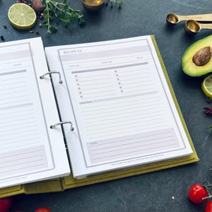 An opened recipe book page with a pink header that reads 'RECIPE for'. The recipe book page has sections for prep time, cook time, serves, ingredients, directions, and notes. A5 size binder with 2 rings.