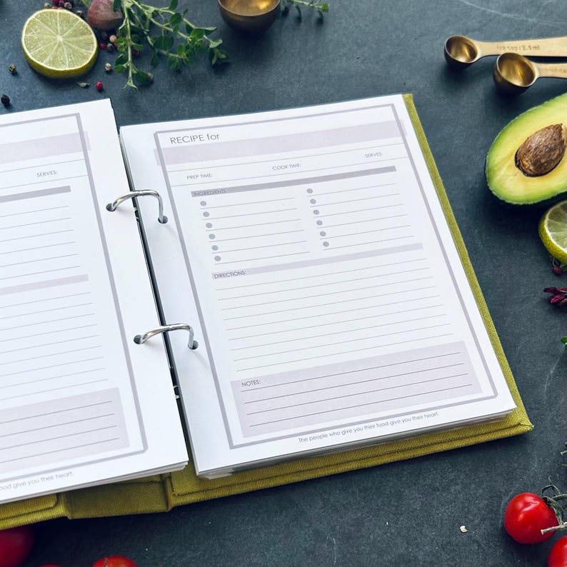 An opened recipe book page with a pink header that reads 'RECIPE for'. The recipe book page has sections for prep time, cook time, serves, ingredients, directions, and notes. A5 size binder with 2 rings.